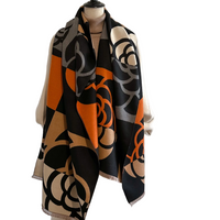 Patterned scarf draped over a mannequin against a white background