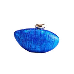Blue marble-textured clutch bag with a gold clasp on a light purple background