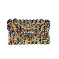 Multicolored beaded handbag with gold handle on a white surface